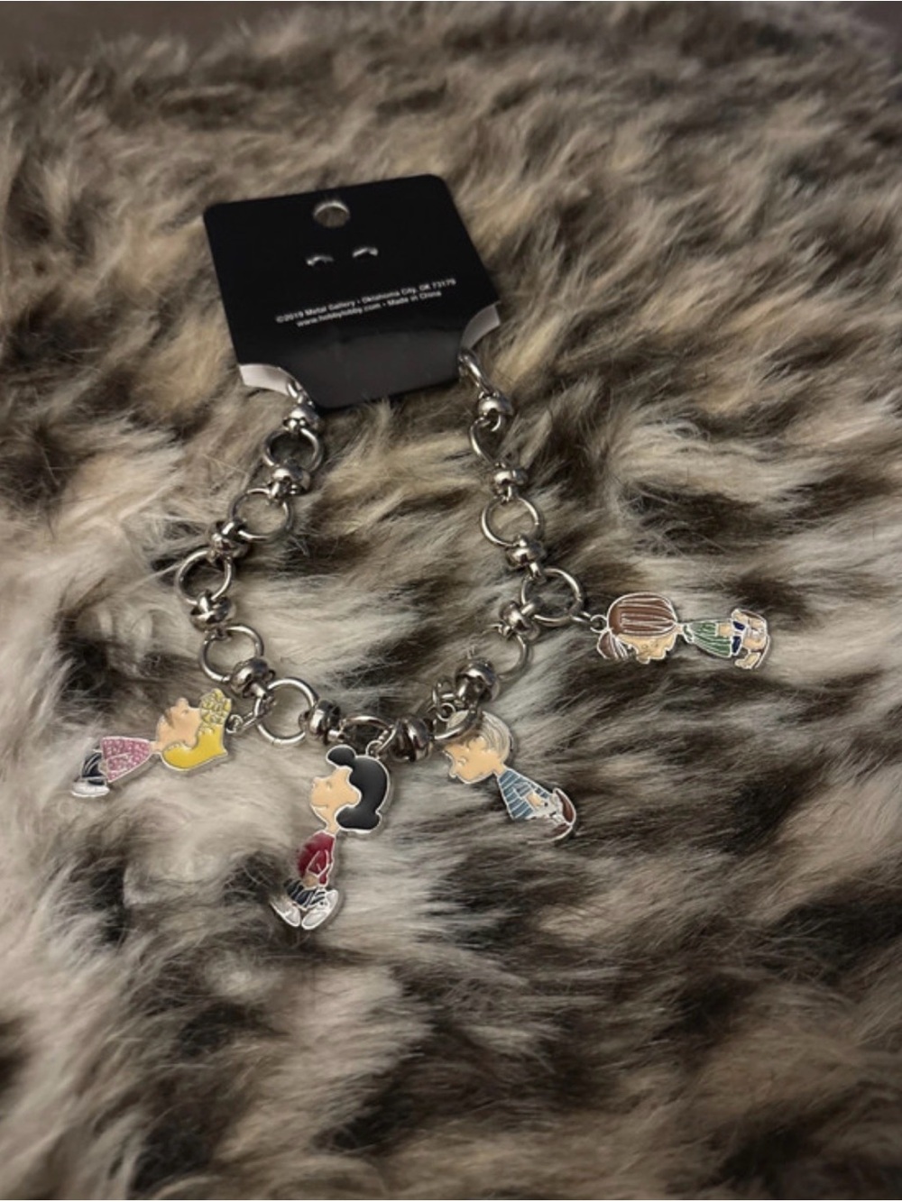 Silver colored bracelet with Snoop character charms